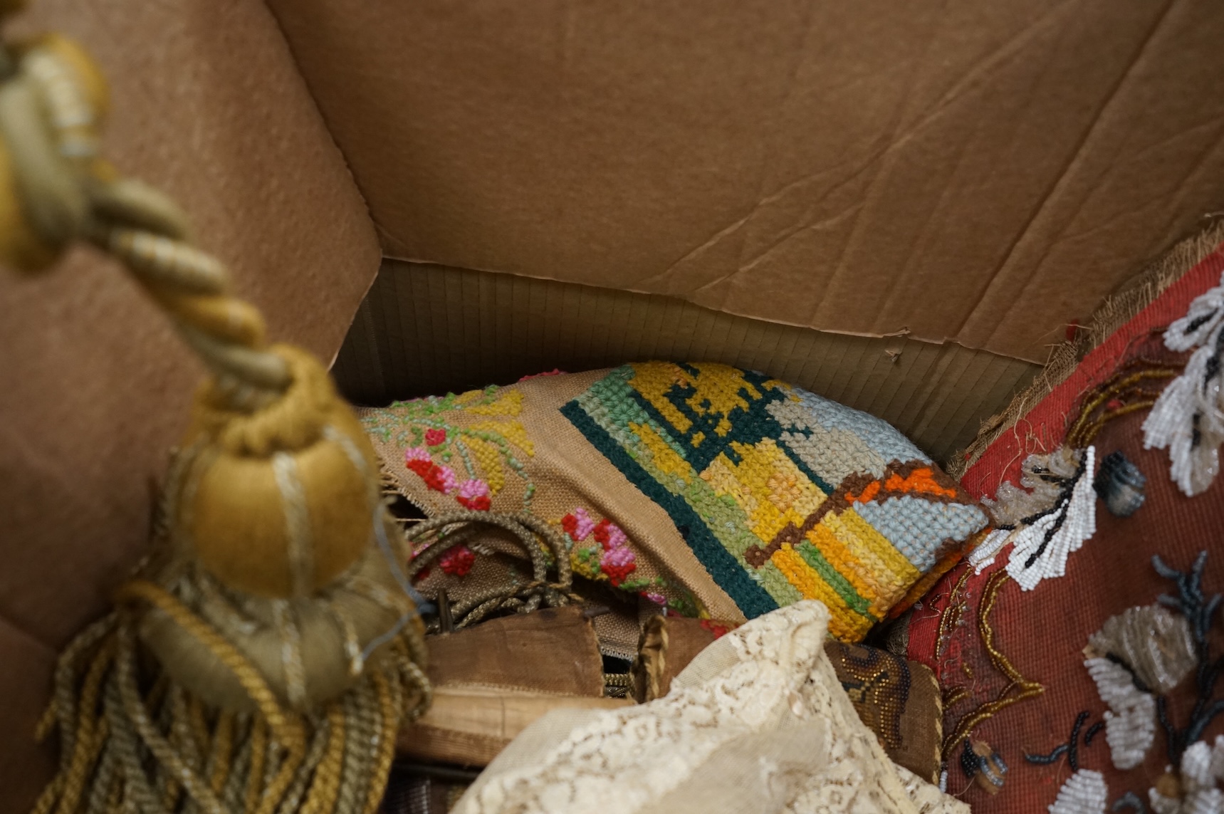A 19th century beadwork panel and bell pull, various samples of printed textiles, a collection of corded and tasselled tie backs, etc.